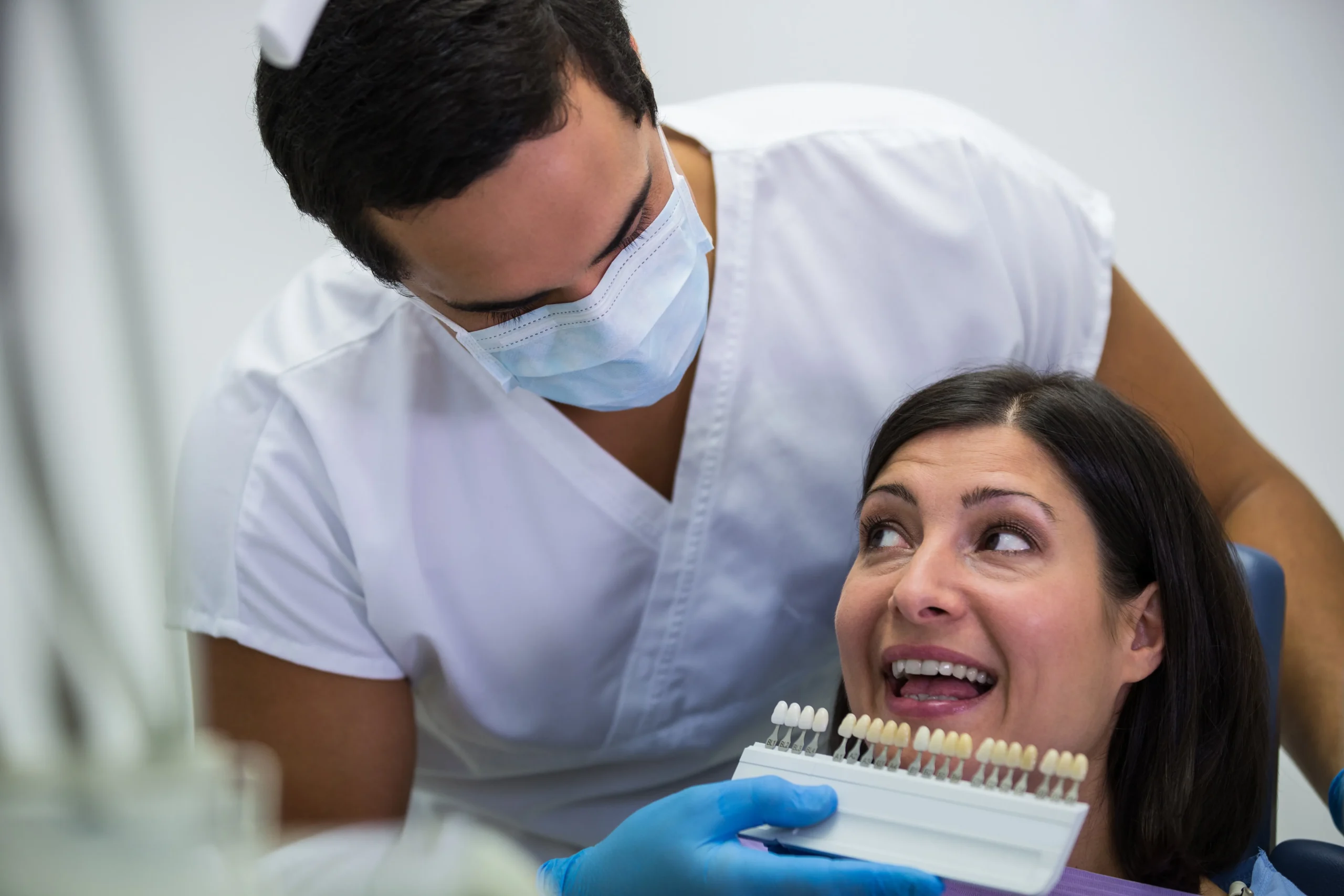 Dentist in San Antonio TX placing a dental crown on a patient's damaged tooth